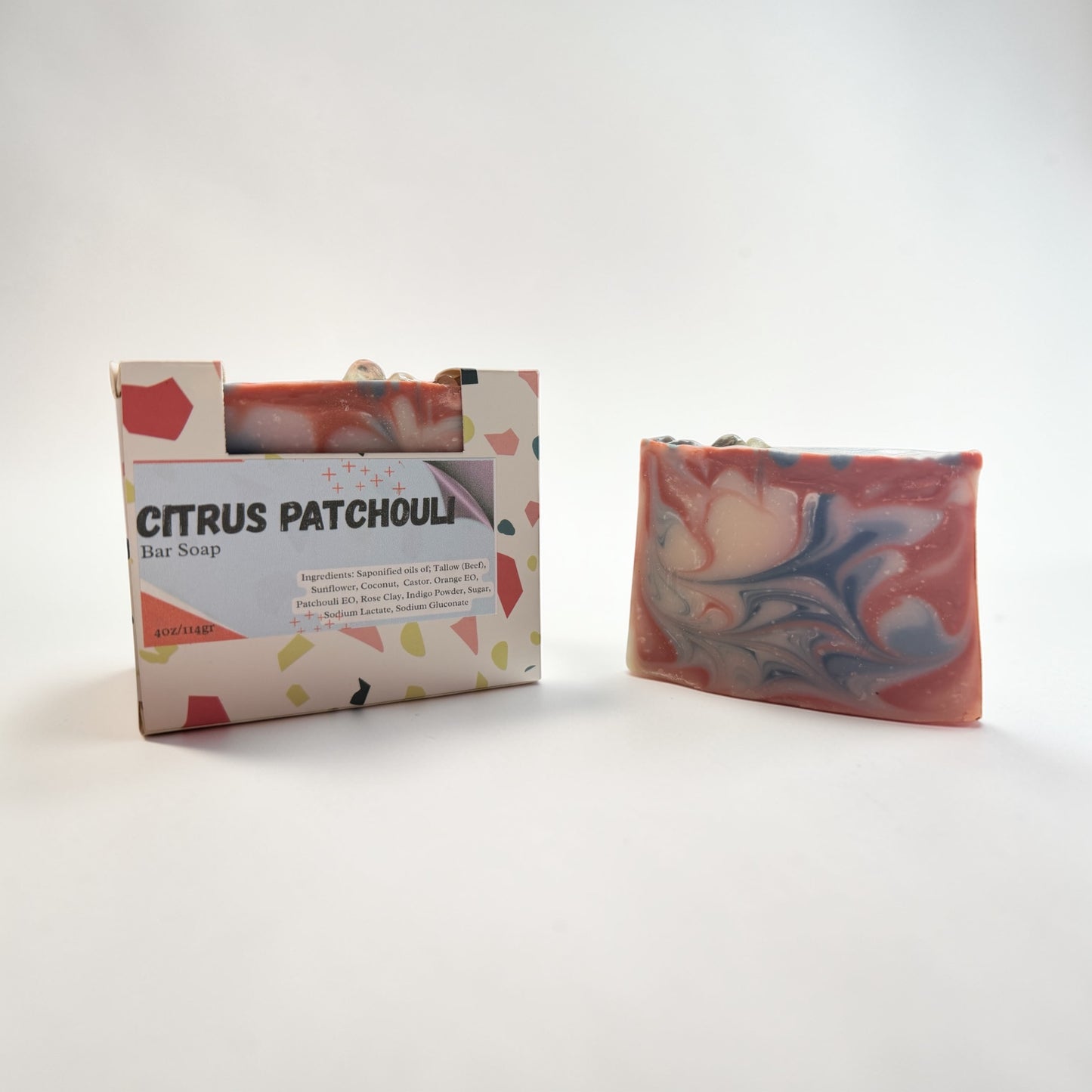 Marbled bar soap with packaging labeled 'Citrus Patchouli' on a white background