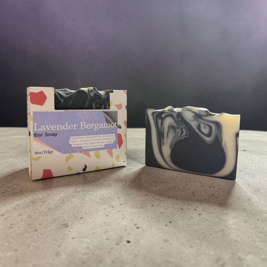 Bar of soap with a colorful label on a gray surface against a dark background