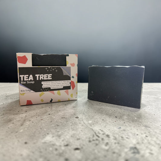 Tea tree bar soap with packaging on a gray surface