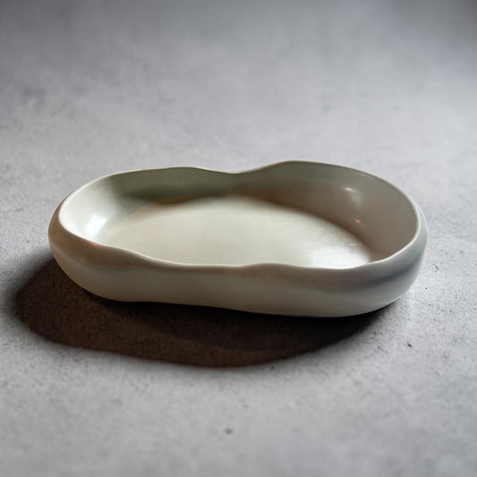 A grey cement tray in an irregular shape