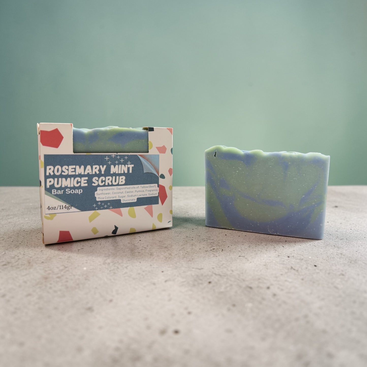 Rosemary Mint Pumice Scrub bar soap with packaging on a neutral background