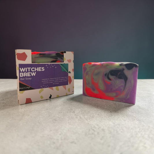 Colorful bar soap with packaging labeled 'Witches Brew' on a textured surface.